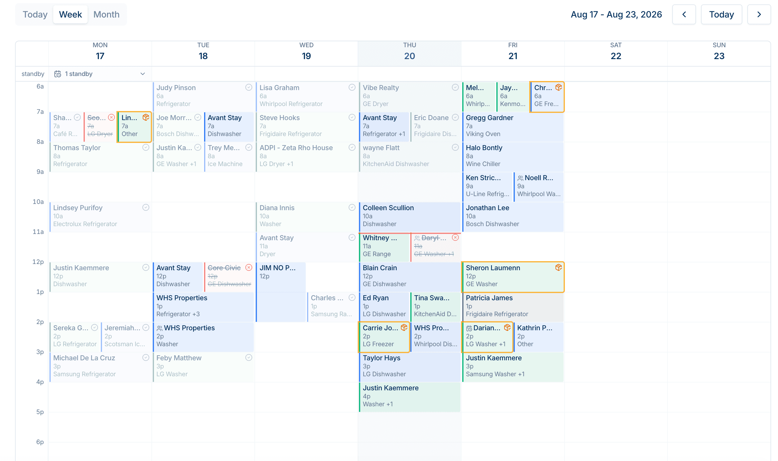 A real week on the schedule: jobs coloured by technician, status icons, and a standby row.